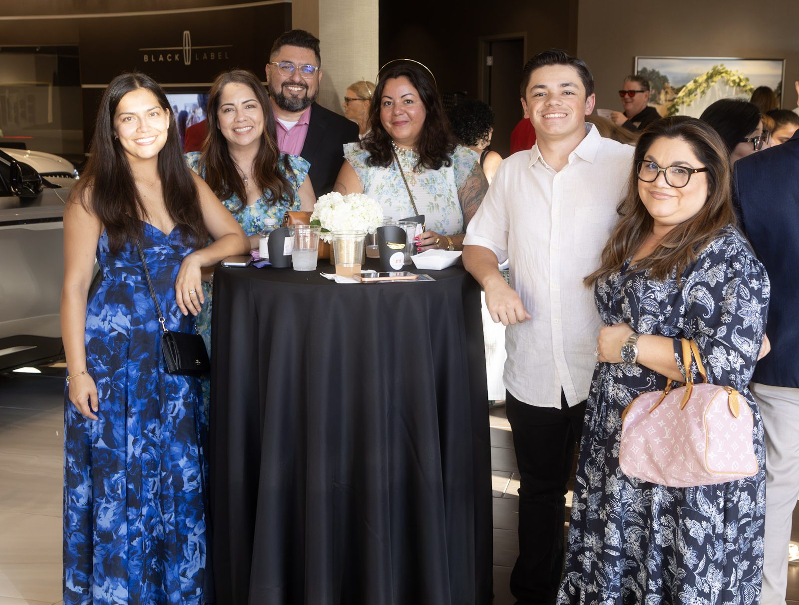 Guests gathered around a cocktail table at the reception